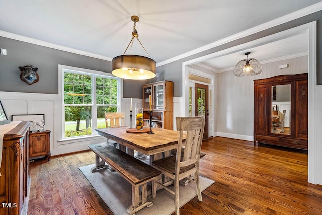 201 Margaret Mann Way, Pittsboro, NC 27312 - dining space featuring wood finished floors, a decorative wall, crown molding, and a wainscoted wall