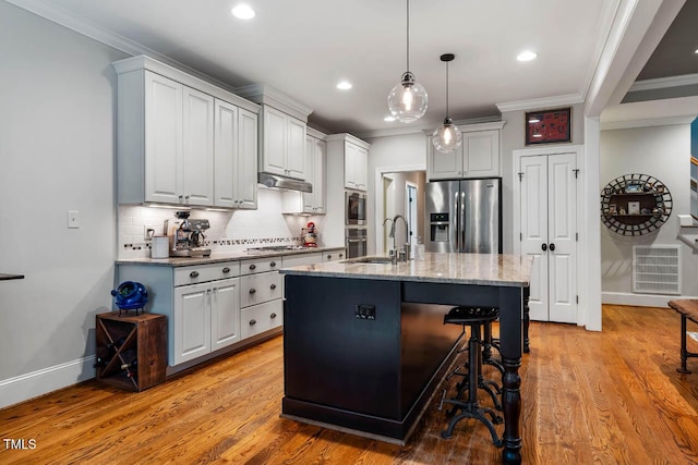201 Margaret Mann Way, Pittsboro, NC 27312 - kitchen featuring appliances with stainless steel finishes, a sink, ornamental molding, backsplash, and light wood-style floors