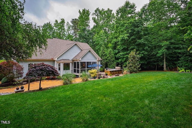 201 Margaret Mann Way, Pittsboro, NC 27312 - back of property featuring a sunroom, a yard, and a shingled roof