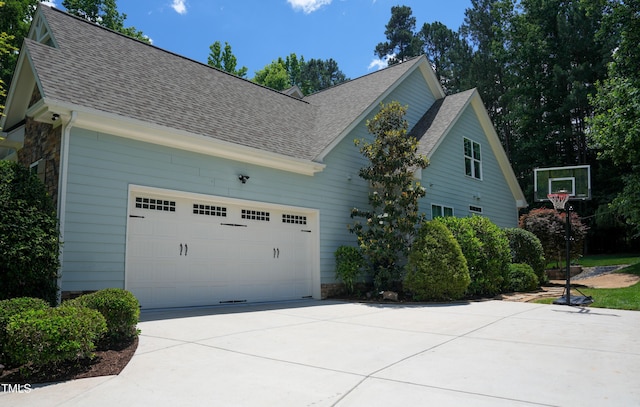 201 Margaret Mann Way, Pittsboro, NC 27312 - view of home's exterior with driveway, roof with shingles, and stone siding