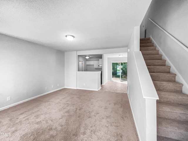 2705 Ramblegate Ln, Durham, NC 27705 - unfurnished living room with carpet floors, a textured ceiling, baseboards, and stairway