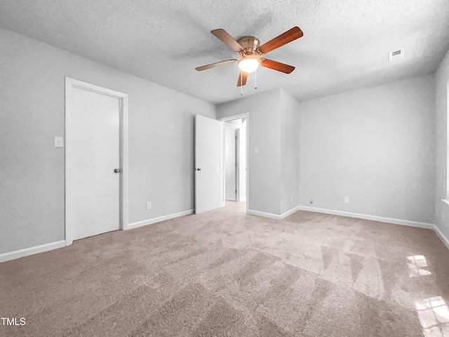 2705 Ramblegate Ln, Durham, NC 27705 - unfurnished bedroom featuring carpet floors, a textured ceiling, baseboards, and a ceiling fan