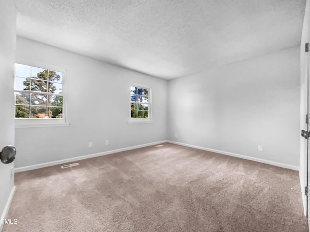 2705 Ramblegate Ln, Durham, NC 27705 - carpeted spare room with a textured ceiling and baseboards