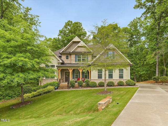 374 Crimson Way, Pittsboro, NC 27312 - craftsman inspired home featuring a porch, a front yard, and stone siding