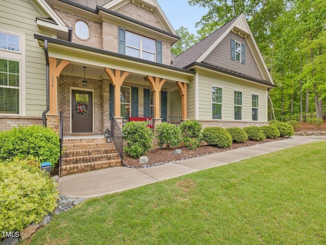 374 Crimson Way, Pittsboro, NC 27312 - craftsman inspired home featuring brick siding, a porch, and a front lawn