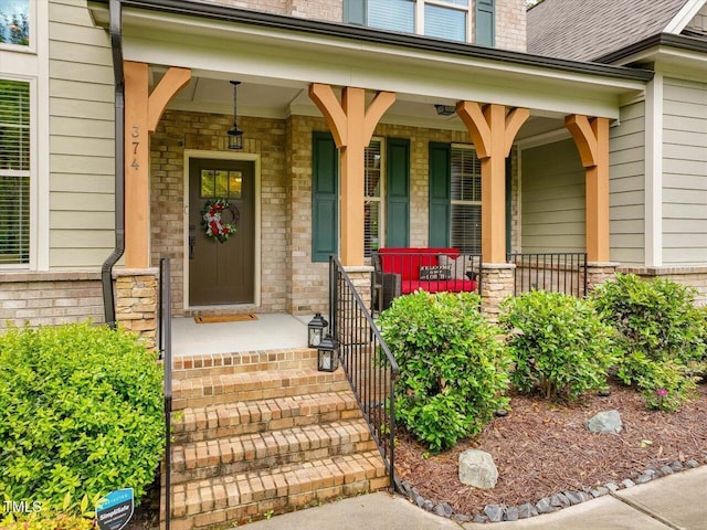 374 Crimson Way, Pittsboro, NC 27312 - doorway to property with covered porch and brick siding