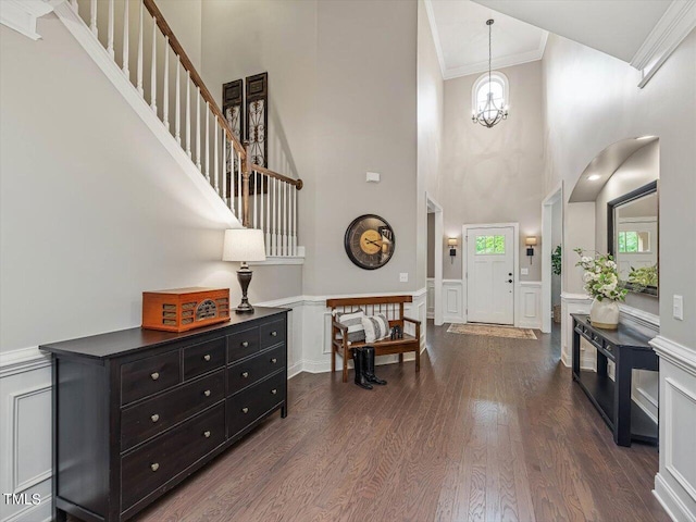 374 Crimson Way, Pittsboro, NC 27312 - entryway with a towering ceiling, ornamental molding, a decorative wall, dark wood finished floors, and wainscoting