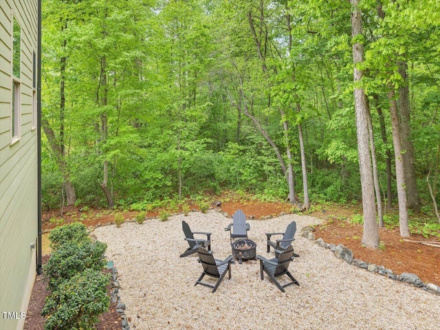 374 Crimson Way, Pittsboro, NC 27312 - view of yard with a fire pit and a wooded view