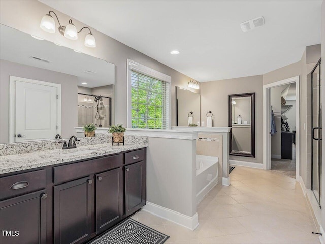 374 Crimson Way, Pittsboro, NC 27312 - bathroom featuring a shower stall, a bath, vanity, and baseboards