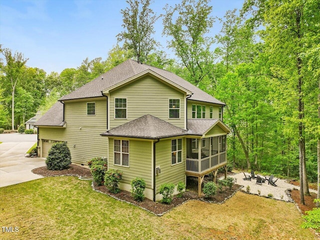 374 Crimson Way, Pittsboro, NC 27312 - rear view of house with a sunroom, driveway, a shingled roof, a yard, and a fire pit