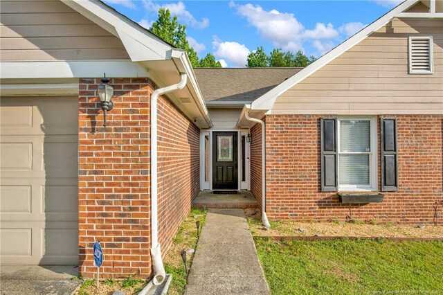 5921 Bloomsbury Dr, Fayetteville, NC 28306 - doorway to property featuring brick siding, a garage, and roof with shingles