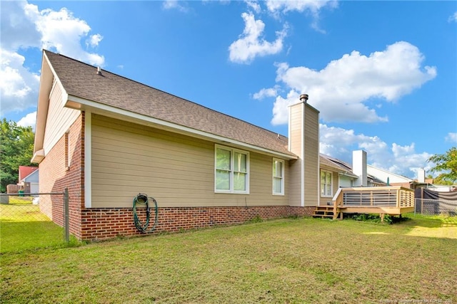 5921 Bloomsbury Dr, Fayetteville, NC 28306 - rear view of house with a wooden deck, brick siding, a chimney, and roof with shingles