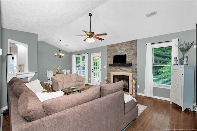 5921 Bloomsbury Dr, Fayetteville, NC 28306 - living room featuring a ceiling fan, vaulted ceiling, dark wood-style flooring, healthy amount of natural light, and a fireplace