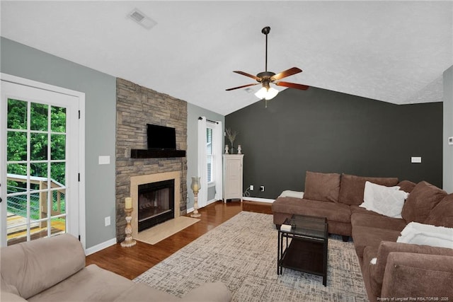 5921 Bloomsbury Dr, Fayetteville, NC 28306 - living room featuring ceiling fan, vaulted ceiling, wood finished floors, baseboards, and a stone fireplace