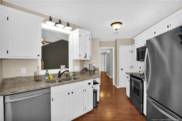 5921 Bloomsbury Dr, Fayetteville, NC 28306 - kitchen with appliances with stainless steel finishes, a sink, dark wood-type flooring, and white cabinets