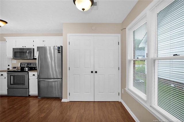 5921 Bloomsbury Dr, Fayetteville, NC 28306 - kitchen with stainless steel appliances, dark wood-style floors, baseboards, and white cabinets