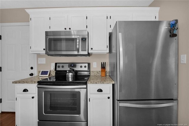 5921 Bloomsbury Dr, Fayetteville, NC 28306 - kitchen featuring stainless steel appliances, white cabinetry, light stone countertops, and dark wood finished floors