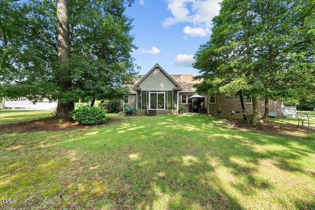 5924 Finish Line Dr, Hope Mills, NC 28348 - back of property featuring a sunroom, brick siding, and crawl space