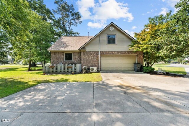 5924 Finish Line Dr, Hope Mills, NC 28348 - traditional-style home featuring brick siding, an attached garage, a front lawn, and driveway