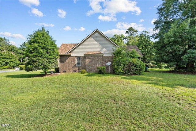 5924 Finish Line Dr, Hope Mills, NC 28348 - view of side of property with a yard, brick siding, and crawl space