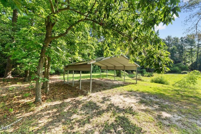 5924 Finish Line Dr, Hope Mills, NC 28348 - view of green lawn with a detached carport and dirt driveway
