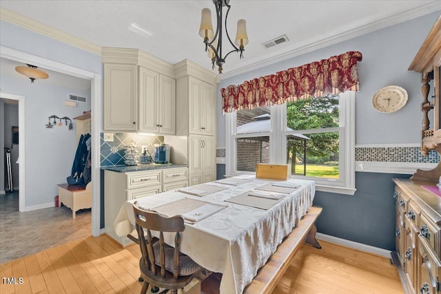 5924 Finish Line Dr, Hope Mills, NC 28348 - dining area with a chandelier, light wood-style floors, and baseboards