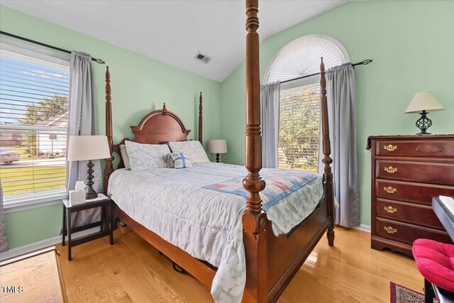 5924 Finish Line Dr, Hope Mills, NC 28348 - bedroom with light wood finished floors, vaulted ceiling, and baseboards