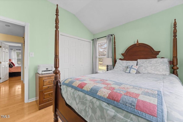 5924 Finish Line Dr, Hope Mills, NC 28348 - bedroom featuring vaulted ceiling, light wood-style flooring, multiple windows, a closet, and baseboards