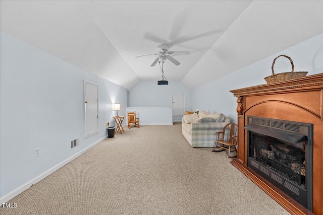 5924 Finish Line Dr, Hope Mills, NC 28348 - living area with carpet, baseboards, vaulted ceiling, ceiling fan, and a fireplace