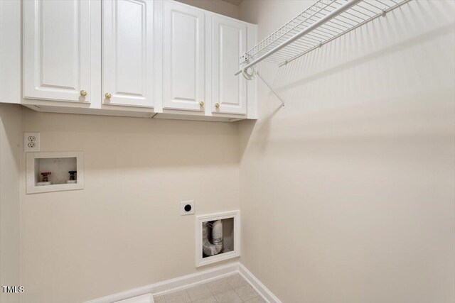 402 Halls Mill Dr, Cary, NC 27519 - laundry room featuring hookup for a washing machine, electric dryer hookup, baseboards, cabinet space, and light tile patterned flooring