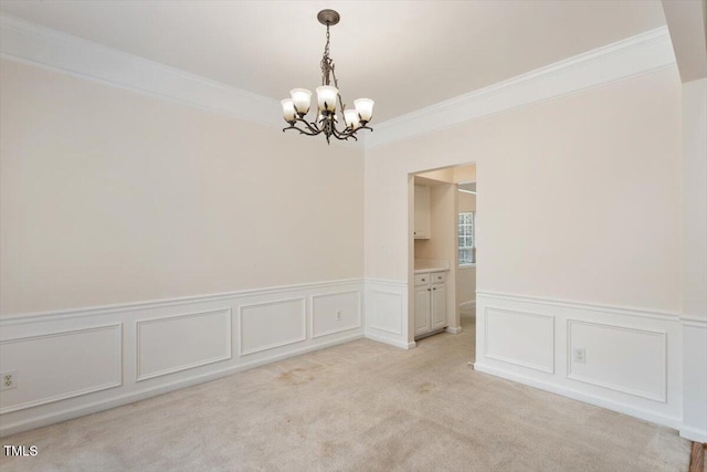 402 Halls Mill Dr, Cary, NC 27519 - spare room with a chandelier, ornamental molding, a wainscoted wall, a decorative wall, and light colored carpet