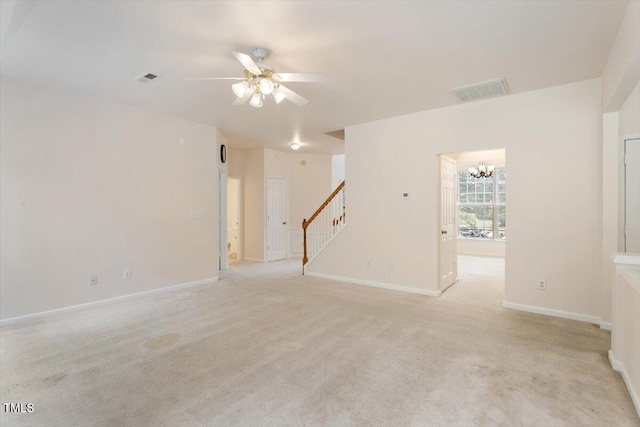 402 Halls Mill Dr, Cary, NC 27519 - unfurnished room featuring stairs, a ceiling fan, a chandelier, light carpet, and baseboards