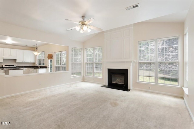 402 Halls Mill Dr, Cary, NC 27519 - unfurnished living room featuring plenty of natural light, a ceiling fan, light carpet, a fireplace, and vaulted ceiling