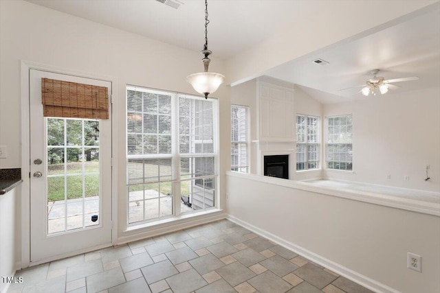 402 Halls Mill Dr, Cary, NC 27519 - unfurnished dining area featuring a glass covered fireplace and a ceiling fan