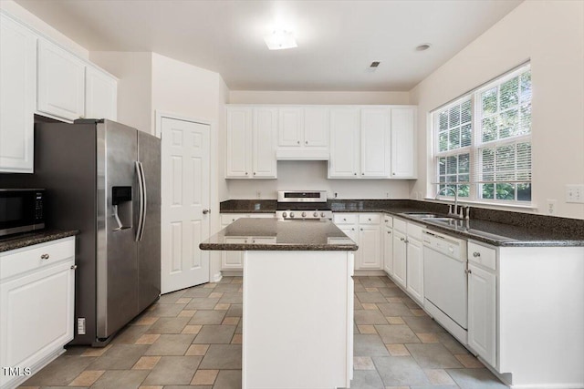 402 Halls Mill Dr, Cary, NC 27519 - kitchen with appliances with stainless steel finishes, a sink, stone finish flooring, a kitchen island, and white cabinets