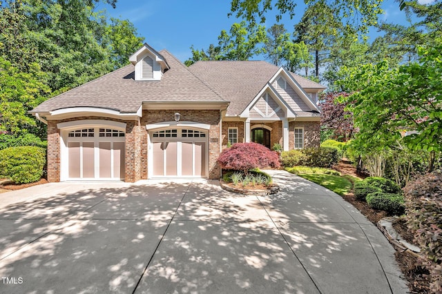 84307 Winslow, Chapel Hill, NC 27517 - view of front of home featuring driveway, brick siding, a garage, and roof with shingles