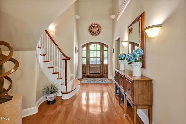 84307 Winslow, Chapel Hill, NC 27517 - foyer featuring wood finished floors, arched walkways, stairs, and a towering ceiling