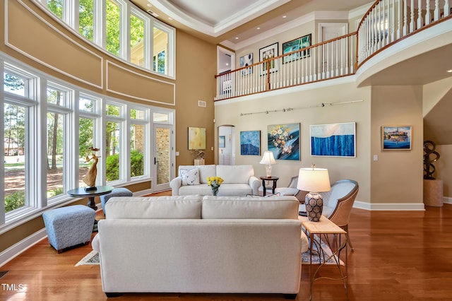 84307 Winslow, Chapel Hill, NC 27517 - living area featuring a towering ceiling, wood finished floors, and ornamental molding