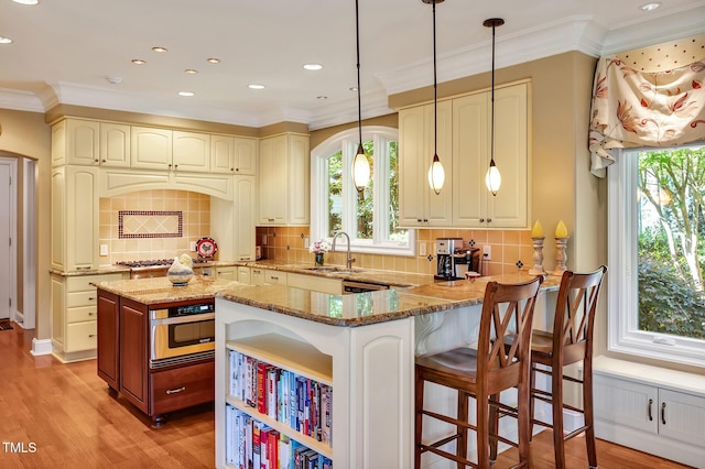 84307 Winslow, Chapel Hill, NC 27517 - kitchen featuring light stone countertops, healthy amount of natural light, tasteful backsplash, light wood finished floors, and crown molding