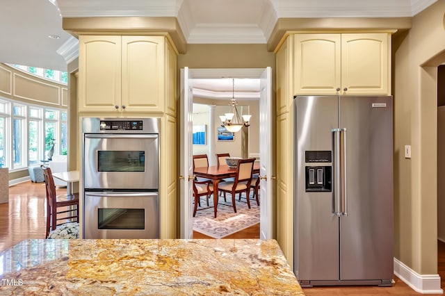 84307 Winslow, Chapel Hill, NC 27517 - kitchen with appliances with stainless steel finishes, cream cabinetry, ornamental molding, a chandelier, and light wood-style floors