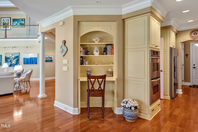 84307 Winslow, Chapel Hill, NC 27517 - hallway with decorative columns, light wood-style floors, ornamental molding, recessed lighting, and built in shelves