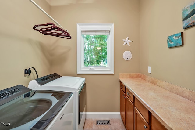 84307 Winslow, Chapel Hill, NC 27517 - washroom featuring washing machine and clothes dryer, cabinet space, and light tile patterned floors