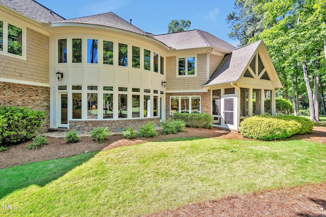84307 Winslow, Chapel Hill, NC 27517 - rear view of property with brick siding, a yard, a shingled roof, and a sunroom
