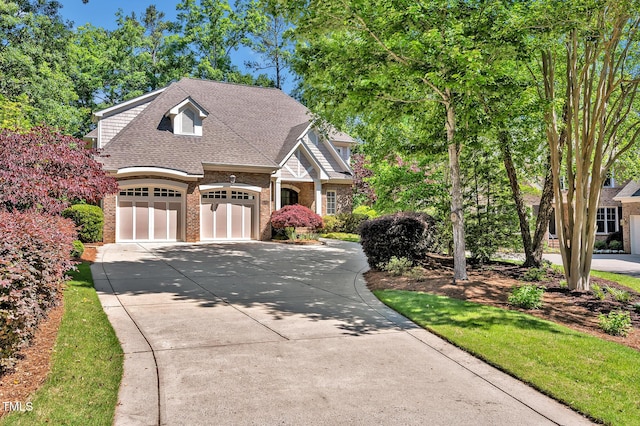 84307 Winslow, Chapel Hill, NC 27517 - view of front of house featuring brick siding, driveway, roof with shingles, and a garage