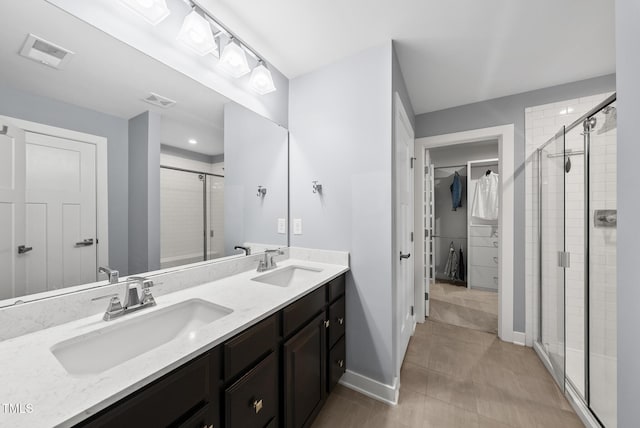 2909 Landon Pines Ct, New Hill, NC 27562 - bathroom with a spacious closet, a stall shower, double vanity, and baseboards