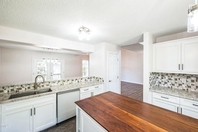 5505 Pennfine Dr, Raleigh, NC 27610 - kitchen featuring white dishwasher, butcher block countertops, a sink, decorative backsplash, and white cabinets