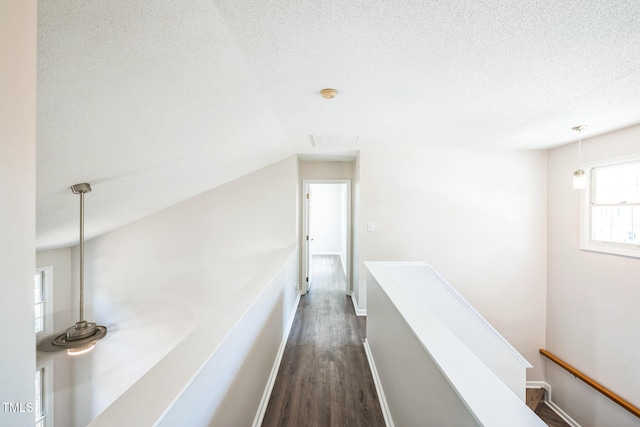 5505 Pennfine Dr, Raleigh, NC 27610 - hall featuring an upstairs landing, dark wood-style floors, a textured ceiling, and baseboards