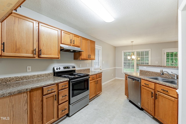5008 Dantonville Ct, Knightdale, NC 27545 - kitchen featuring appliances with stainless steel finishes, under cabinet range hood, a sink, light flooring, and a chandelier