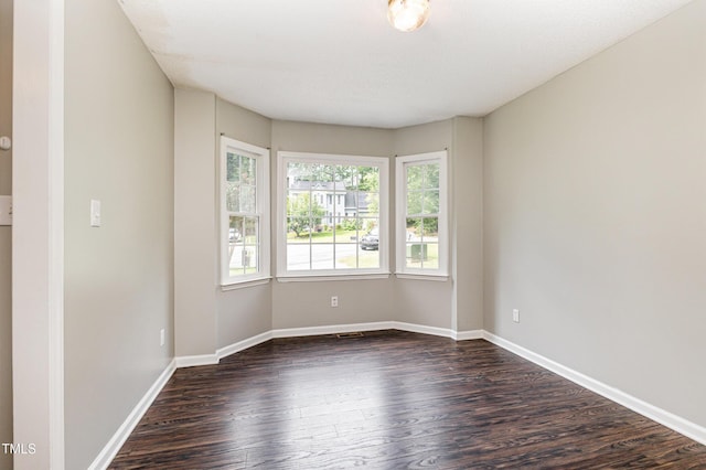 5008 Dantonville Ct, Knightdale, NC 27545 - spare room with healthy amount of natural light, dark wood-type flooring, and baseboards