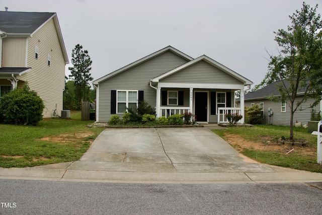 764 Grove Creek Ln, Raleigh, NC 27610 - view of front of house featuring covered porch, a front yard, and central AC unit